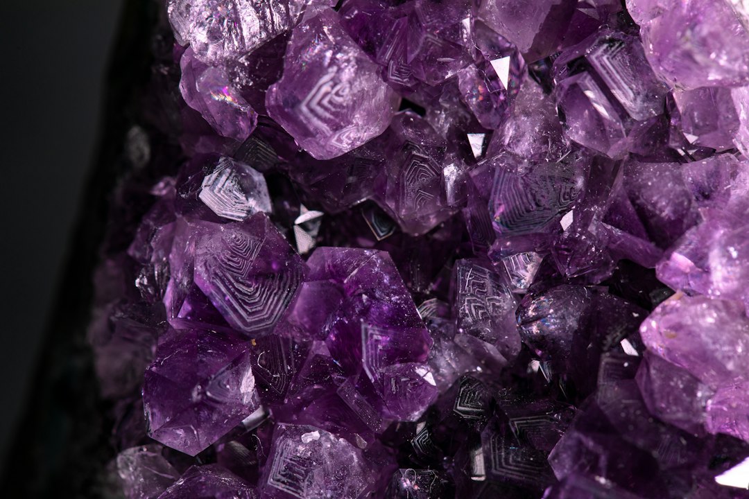 Natural purple and dark crystal stones arranged for a mindful home decor setting